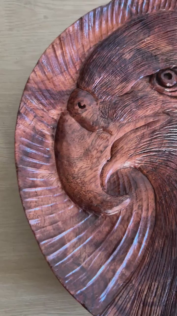 Eagle tray: silent close-up of the round tray, showing its eagle-head motif and carved lines, then standing upright.