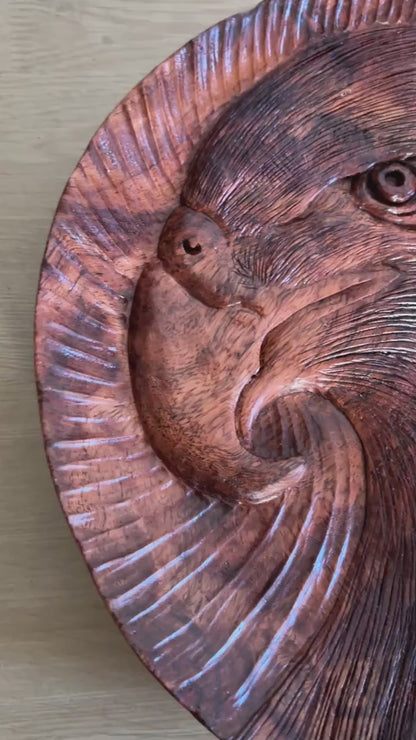 Eagle tray: silent close-up of the round tray, showing its eagle-head motif and carved lines, then standing upright.