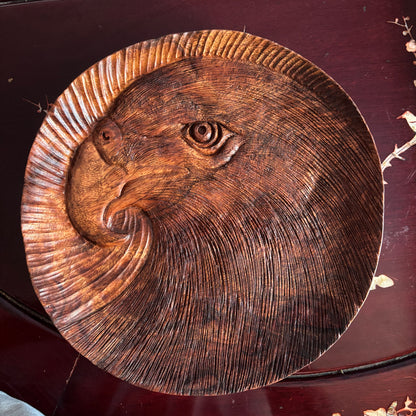 Eagle tray: round wooden tray with an eagle-head motif and sweeping carved lines.